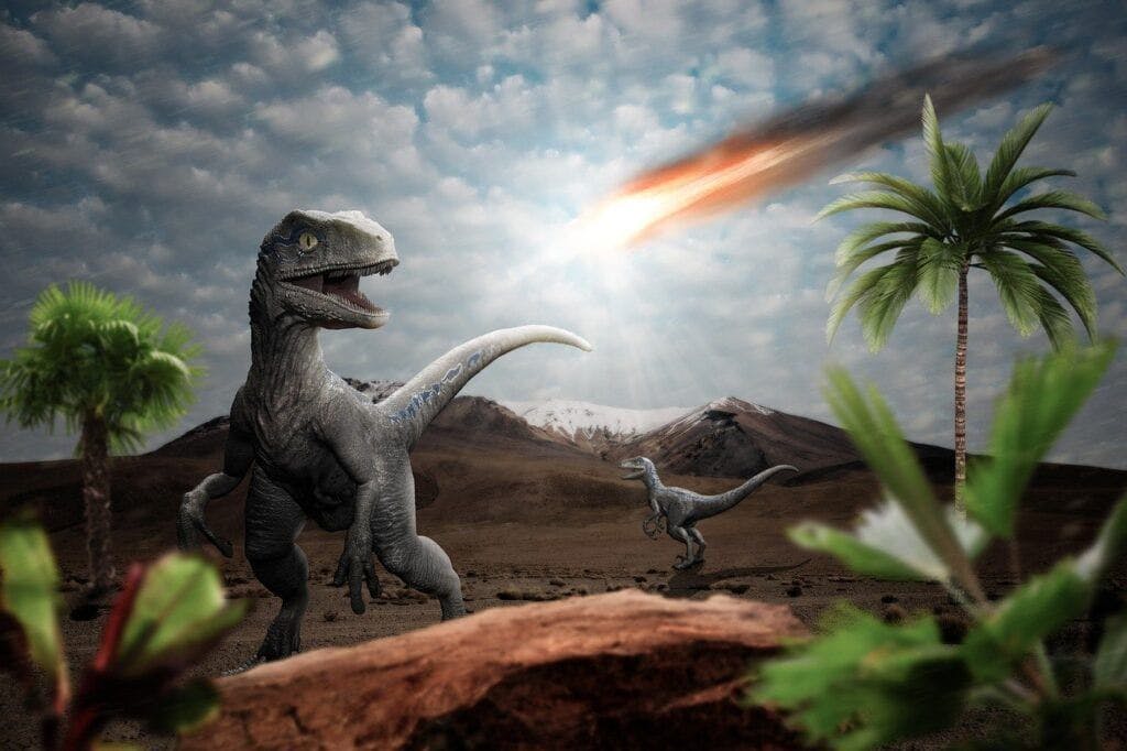 Imagen de dinosaurios con un meteorito de fondo